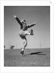 Boy Kicking a Football by Anonymous