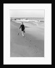 Woman Walking on Beach Leaving Footprints by Anonymous