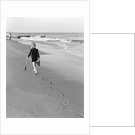 Woman Walking on Beach Leaving Footprints by Anonymous