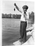 Boy Holding a Small Fish by Anonymous