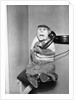 Monkey in Clothing Holds Phone Receiver by Anonymous