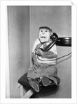 Monkey in Clothing Holds Phone Receiver by Anonymous