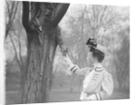 Woman Feeding a Squirrel by Anonymous