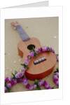 Ukelele and garland, elevated view by Anonymous