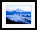 Distant view of Mount Fuji silhouetted against blue sky by Anonymous
