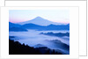 Distant view of Mount Fuji silhouetted against blue sky by Anonymous