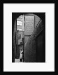 Man Outside Ye Olde Mitre Tavern by Corbis