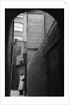 Man Outside Ye Olde Mitre Tavern by Corbis