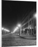 Street Lights Along a Cobblestone Street by Anonymous