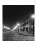 Street Lights Along a Cobblestone Street by Anonymous