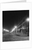 Street Lights Along a Cobblestone Street by Anonymous