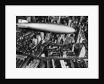The German airship, the Hindenburg, above Manhattan, New York in 1936, on its way to its berth at Lakehurst , New Jersey, the same place where it inexplicably burst into flames the next year. by Anonymous