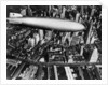 The German airship, the Hindenburg, above Manhattan, New York in 1936, on its way to its berth at Lakehurst , New Jersey, the same place where it inexplicably burst into flames the next year. by Anonymous