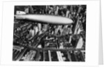 The German airship, the Hindenburg, above Manhattan, New York in 1936, on its way to its berth at Lakehurst , New Jersey, the same place where it inexplicably burst into flames the next year. by Anonymous