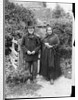 Elderly Couple Standing by Fence by Anonymous