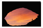 Hiker Climbing a Natural Arch in Utah by Anonymous