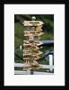 Mileage Sign Pointing Directions in Puerto Williams by Anonymous