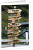 Mileage Sign Pointing Directions in Puerto Williams by Anonymous