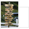 Mileage Sign Pointing Directions in Puerto Williams by Anonymous