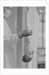 Doctor Holds New Born Baby by his Feet by Anonymous
