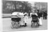 Nannies and Children Strolling in Park by Anonymous
