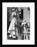 Woman Talking on Wall Mounted Telephone by Anonymous