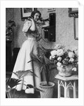 Woman Talking on Wall Mounted Telephone by Anonymous