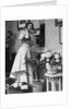 Woman Talking on Wall Mounted Telephone by Anonymous