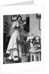 Woman Talking on Wall Mounted Telephone by Anonymous