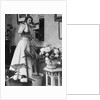 Woman Talking on Wall Mounted Telephone by Anonymous