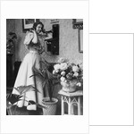 Woman Talking on Wall Mounted Telephone by Anonymous