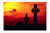 Celtic Crosses Silhouetted at Sunset by Corbis