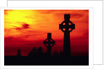 Celtic Crosses Silhouetted at Sunset by Corbis