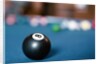 Eight ball on pool table by Anonymous