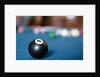 Eight ball on pool table by Anonymous