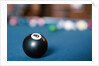 Eight ball on pool table by Anonymous