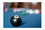 Eight ball on pool table by Anonymous