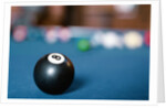 Eight ball on pool table by Anonymous