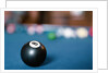 Eight ball on pool table by Anonymous