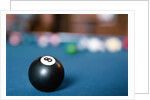 Eight ball on pool table by Anonymous
