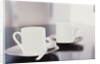 Two coffee cups on a table by Anonymous