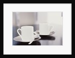 Two coffee cups on a table by Anonymous