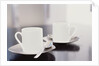 Two coffee cups on a table by Anonymous