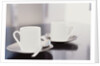 Two coffee cups on a table by Anonymous