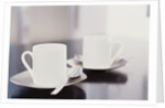 Two coffee cups on a table by Anonymous