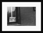 Sign Posted in Window of Building by Anonymous