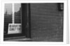 Sign Posted in Window of Building by Anonymous