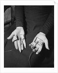 Pair of Hands Wearing Lie Detector Device by Anonymous