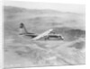 Airplane Flying Over Landscape by Anonymous