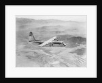 Airplane Flying Over Landscape by Anonymous